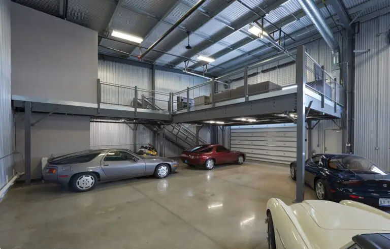 Two story freestanding mezzanine with several sports car around it