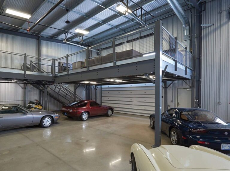 Two story freestanding mezzanine with several sports car around it
