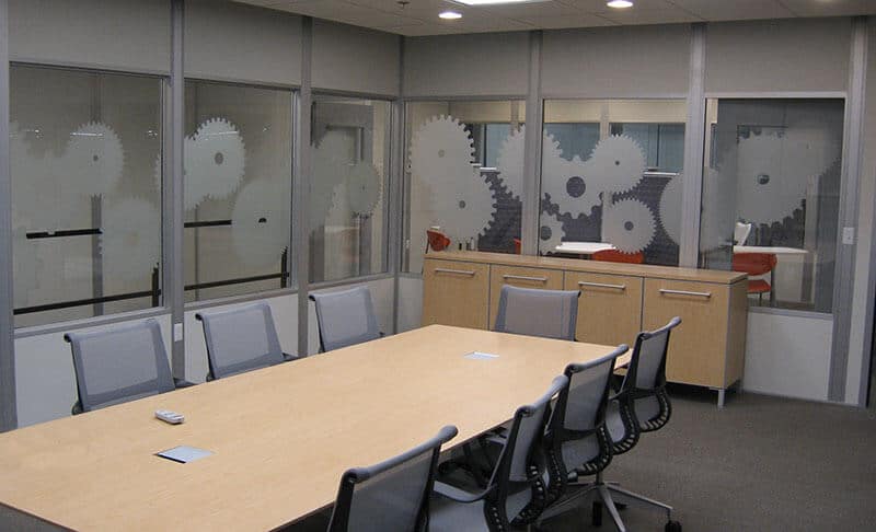 Conference room interior of modular office with gear art on glass