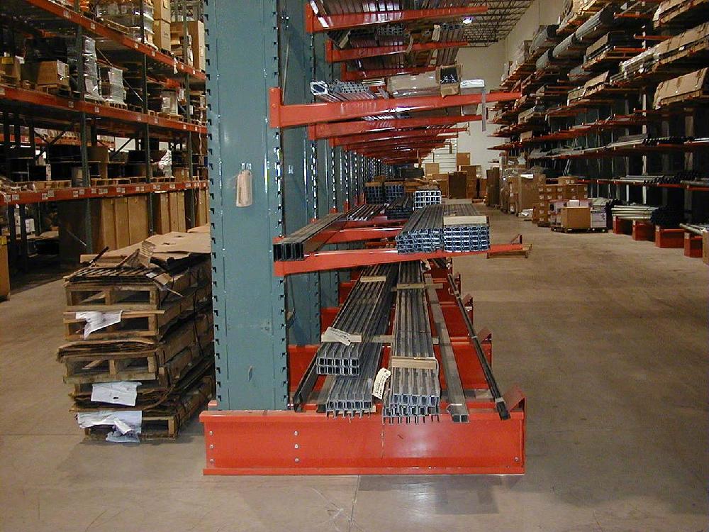 interlake cantilever pallet rack with green uprights and orange beams