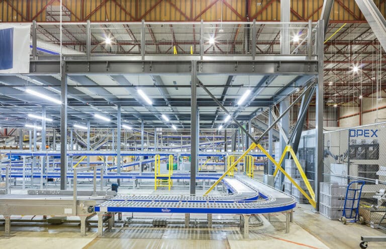 Warehouse mezzanine installed above warehouse conveyor